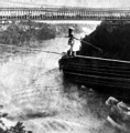 Maria Spelterini crossing the Niagara gorge on a tightrope on July 4, 1876 caption for suspension bridge picture